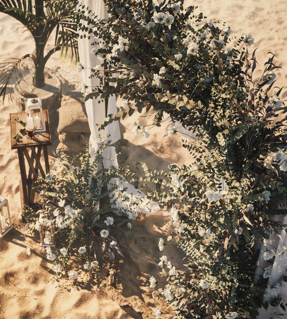 greek wedding in island with sand, plants and white sheets