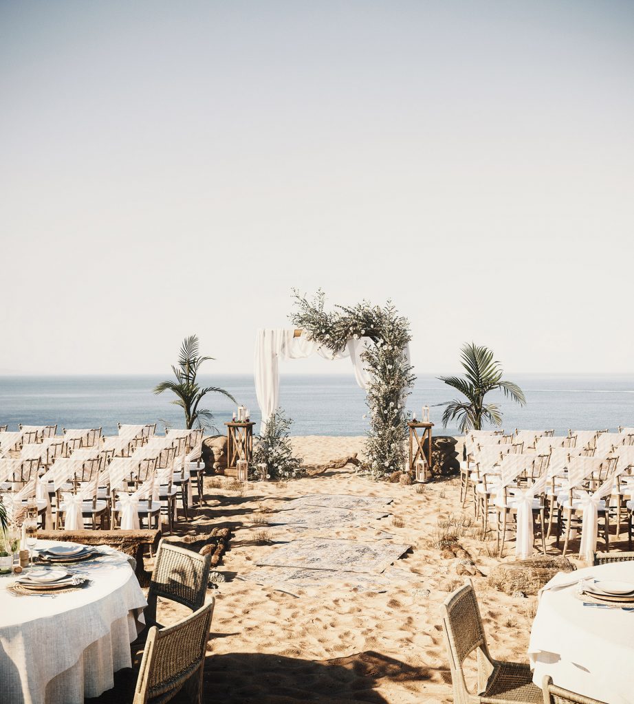 greek wedding in an island with sand and white tables and chairs